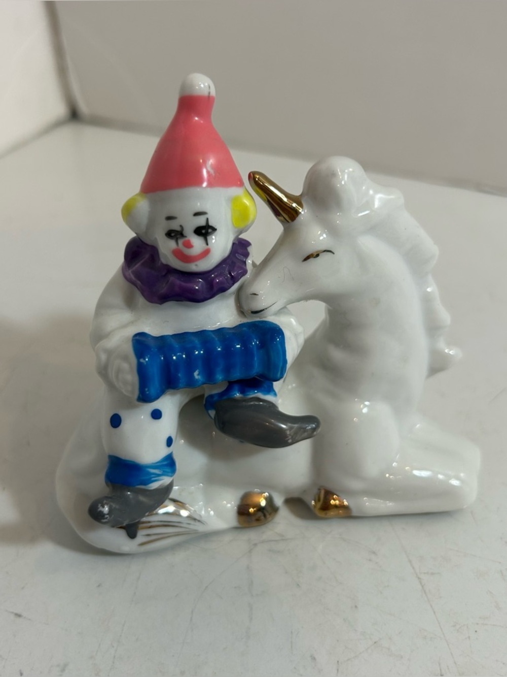 Vintage porcelain clown atop unicorn with gold accents‎ figurine Knick knack